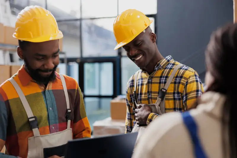 picture of factory workers wearing yellow helmets