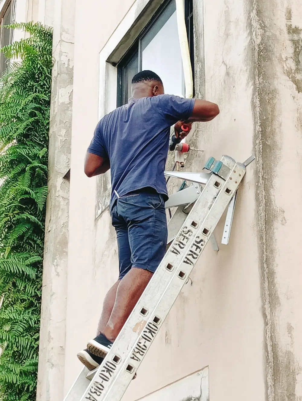 technician working while on a ladder