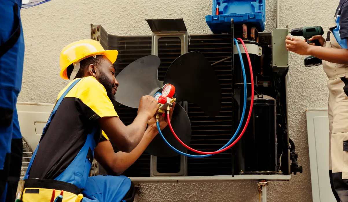 worker refilling hvac system refrigerant